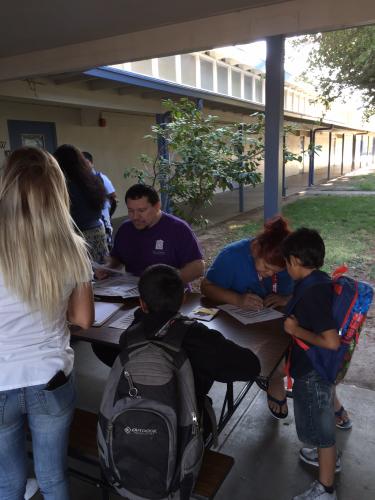 Mr. Gutierrez, Masters Program, signs students up for the extending learning program