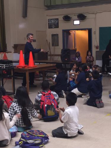 Pacific families make musical poppers with Phil Tulga.